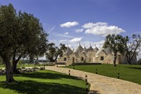 Manicured lawns and stone-flagged paths link the two houses. 